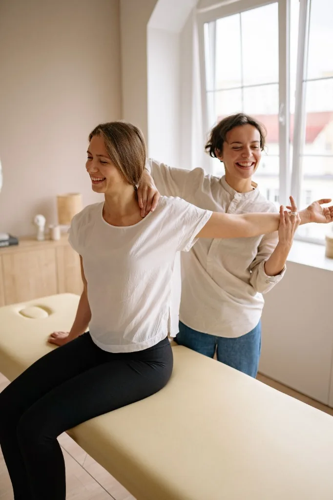 Expert physiotherapist conducting at-home joint assessment for West Midlands patient